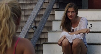 Movie still from “The Way Way Back” (2013), directed by Jim Rash – A beautiful young lady sitting on steps in front of a building; Medium shot, Over the shoulder angle