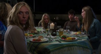 Movie still from “The Way Way Back” (2013), directed by Jim Rash – A group of people sitting at a dinner table; Medium shot, Over the shoulder angle