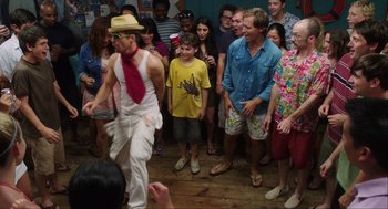 Movie still from “The Way Way Back” (2013), directed by Jim Rash – A group of people watching a man dance; Wide shot, Over the shoulder angle
