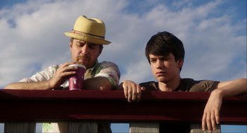 Movie still from “The Way Way Back” (2013), directed by Jim Rash – A man and a boy leaning on a railing; Medium shot, Low angle
