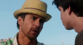 Movie still from “The Way Way Back” (2013), directed by Jim Rash – A man wearing a straw hat talking to a boy; Close Up shot, Over the shoulder angle