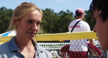Movie still from “The Way Way Back” (2013), directed by Jim Rash – A person near a fence; Close Up shot, Over the shoulder angle
