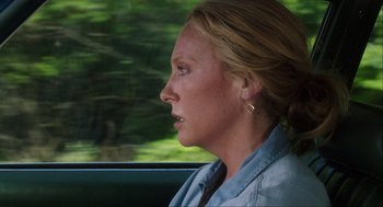 Movie still from “The Way Way Back” (2013), directed by Jim Rash – A woman sitting in a car looking out the window; Close Up shot, Over the shoulder angle
