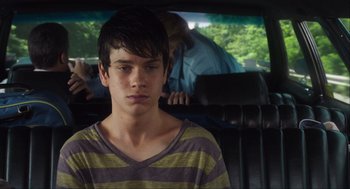 Movie still from “The Way Way Back” (2013), directed by Jim Rash – A young man sitting in the back seat of a car; Close Up shot, Over the shoulder angle