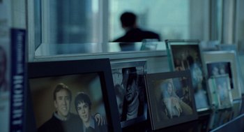 Movie still from “The Weather Man” (2005), directed by Gore Verbinski – A couple of pictures are hanging on a wall; Medium shot, Over the shoulder angle