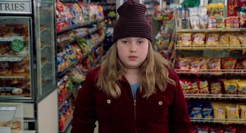 Movie still from “The Weather Man” (2005), directed by Gore Verbinski – A young girl wearing a hat in a grocery store; Close Up shot, High angle