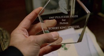 Movie still from “The Weather Man” (2005), directed by Gore Verbinski – A person holding a glass award in their hand; Extreme Close Up shot, High angle