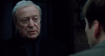 Movie still from “The Weather Man” (2005), directed by Gore Verbinski – An older man in a black jacket looking at the camera; Close Up shot, Over the shoulder angle