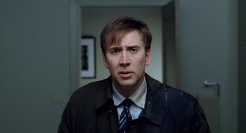 Movie still from “The Weather Man” (2005), directed by Gore Verbinski – A person wearing a suit and tie; Close Up shot, Low angle