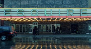 Movie still from “The Weather Man” (2005), directed by Gore Verbinski – People are standing in front of a movie theater; Extreme Wide shot, Low angle