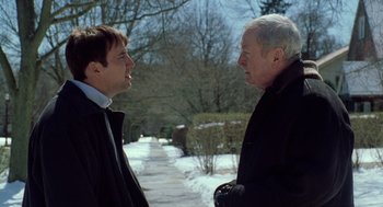 Movie still from “The Weather Man” (2005), directed by Gore Verbinski – Two men standing next to each other on a snowy day; Medium shot, Over the shoulder angle