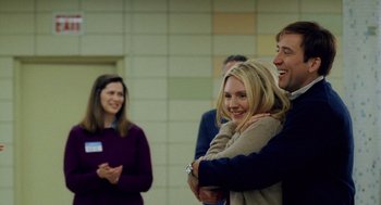 Movie still from “The Weather Man” (2005), directed by Gore Verbinski – A man and a woman hugging in front of a group of people; Medium shot, Over the shoulder angle