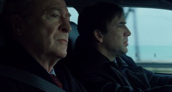 Movie still from “The Weather Man” (2005), directed by Gore Verbinski – Two men sitting in the back seat of a car; Close Up shot, Over the shoulder angle