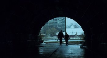 Movie still from “The Weather Man” (2005), directed by Gore Verbinski – Two people walking under a bridge in the rain; Extreme Wide shot, Low angle