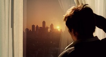 Movie still from “The Weather Man” (2005), directed by Gore Verbinski – A man looking out of a window at the sun setting; Extreme Close Up shot, Over the shoulder angle
