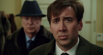 Movie still from “The Weather Man” (2005), directed by Gore Verbinski – A man in a suit and tie next to another man in a suit and tie; Close Up shot, Over the shoulder angle