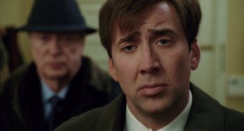 Movie still from “The Weather Man” (2005), directed by Gore Verbinski – A person wearing a suit and hat; Close Up shot, Over the shoulder angle