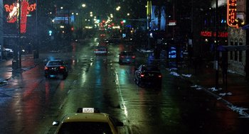 Movie still from “The Weather Man” (2005), directed by Gore Verbinski – Cars driving down a street at night in the rain; Extreme Wide shot, High angle