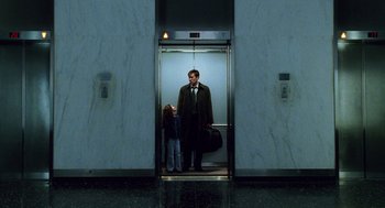 Movie still from “The Weather Man” (2005), directed by Gore Verbinski – A man and a little girl standing in an elevator; Wide shot, Low angle