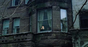 Movie still from “The Weather Man” (2005), directed by Gore Verbinski – A person looking out of a window in a building; Extreme Wide shot, Low angle