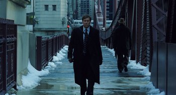Movie still from “The Weather Man” (2005), directed by Gore Verbinski – A man walking across a bridge in the snow; Wide shot, High angle