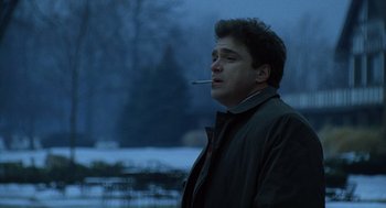 Movie still from “The Weather Man” (2005), directed by Gore Verbinski – A man smoking a cigarette while standing in the snow; Close Up shot, Low angle