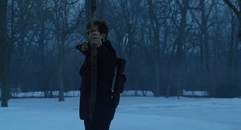 Movie still from “The Weather Man” (2005), directed by Gore Verbinski – A man holding a bow and arrow in the snow; Wide shot, Over the shoulder angle