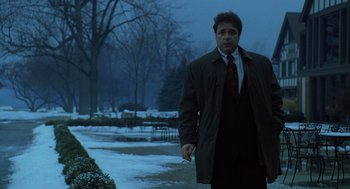 Movie still from “The Weather Man” (2005), directed by Gore Verbinski – A man in a suit and tie walking in the snow; Medium shot, Low angle