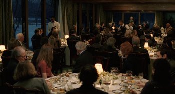 Movie still from “The Weather Man” (2005), directed by Gore Verbinski – A group of people sitting at a table with food on it; Wide shot, High angle