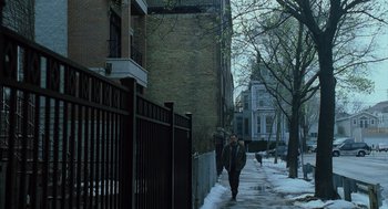 Movie still from “The Weather Man” (2005), directed by Gore Verbinski – A man walking down a sidewalk next to a building; Extreme Wide shot, High angle