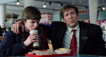 Movie still from “The Weather Man” (2005), directed by Gore Verbinski – Two men sitting at a table with a tray of food; Medium shot, Over the shoulder angle