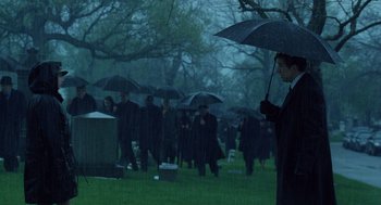 Movie still from “The Weather Man” (2005), directed by Gore Verbinski – A man holding an umbrella in the rain; Wide shot, Over the shoulder angle