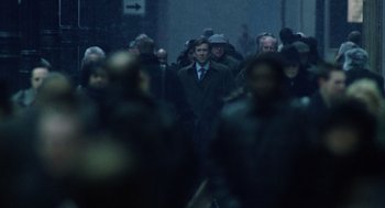 Movie still from “The Weather Man” (2005), directed by Gore Verbinski – A group of people walking down a street in the rain; Wide shot, Over the shoulder angle