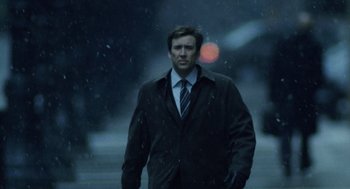 Movie still from “The Weather Man” (2005), directed by Gore Verbinski – A man wearing a suit and tie walking in the rain; Medium shot, Low angle