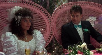 Movie still from “The Wedding Singer” (1998), directed by Frank Coraci – A man and a woman sitting at a table with drinks; Medium shot, High angle