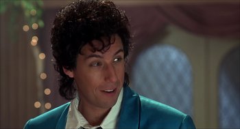 Movie still from “The Wedding Singer” (1998), directed by Frank Coraci – A person wearing a suit and tie; Close Up shot, Low angle