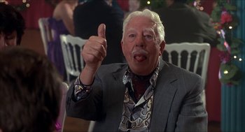 Movie still from “The Wedding Singer” (1998), directed by Frank Coraci – An older man giving a thumbs up sign; Close Up shot, Low angle
