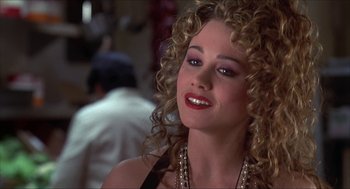 Movie still from “The Wedding Singer” (1998), directed by Frank Coraci – A person with curly blonde hair; Close Up shot, Over the shoulder angle