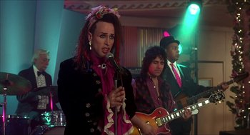 Movie still from “The Wedding Singer” (1998), directed by Frank Coraci – A group of people that are singing together; Medium shot, Over the shoulder angle