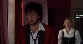 Movie still from “The Wedding Singer” (1998), directed by Frank Coraci – A man in a red jacket standing next to another man in a white shirt; Medium shot, Over the shoulder angle
