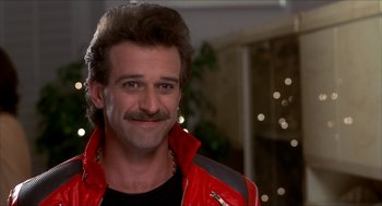 Movie still from “The Wedding Singer” (1998), directed by Frank Coraci – A person wearing a red jacket; Close Up shot, Low angle