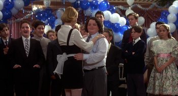 Movie still from “The Wedding Singer” (1998), directed by Frank Coraci – A man and a woman dancing in front of a group of people; Medium shot, Over the shoulder angle