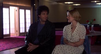 Movie still from “The Wedding Singer” (1998), directed by Frank Coraci – A man and a woman sitting next to each other on a couch; Medium shot, Low angle
