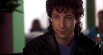 Movie still from “The Wedding Singer” (1998), directed by Frank Coraci – A person with curly hair; Close Up shot, Over the shoulder angle