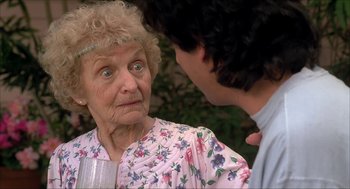 Movie still from “The Wedding Singer” (1998), directed by Frank Coraci – An older woman and a younger man talking; Close Up shot, Over the shoulder angle