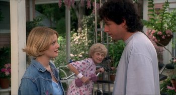 Movie still from “The Wedding Singer” (1998), directed by Frank Coraci – Two women and a man are talking to each other outside; Medium shot, Over the shoulder angle