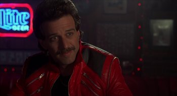 Movie still from “The Wedding Singer” (1998), directed by Frank Coraci – A person wearing a red leather jacket; Close Up shot, Low angle