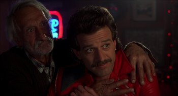 Movie still from “The Wedding Singer” (1998), directed by Frank Coraci – A man in a red jacket and a man in a black jacket; Close Up shot, Over the shoulder angle