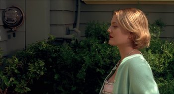 Movie still from “The Wedding Singer” (1998), directed by Frank Coraci – A young blonde haired woman wearing a green jacket; Close Up shot, Over the shoulder angle
