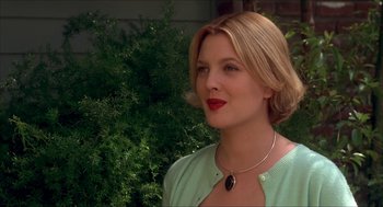 Movie still from “The Wedding Singer” (1998), directed by Frank Coraci – A beautiful blonde woman wearing a green sweater and red lipstick; Close Up shot, Low angle